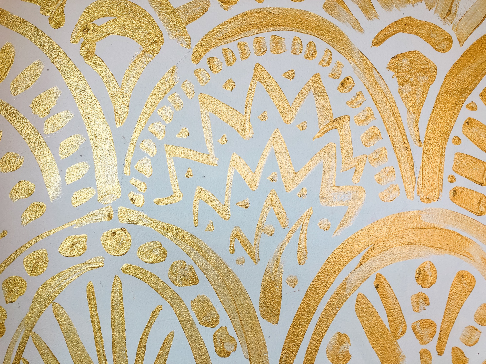 Golden pattern on the white wall background